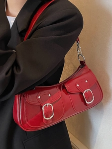 Glossy red patent leather underarm baguette bag with silver buckles and chain strap