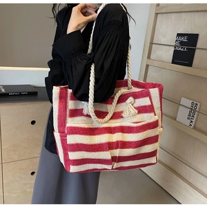Detail of red and white striped woven tote with thick cotton rope handles and tassels