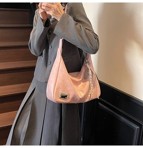 Pink large capacity faux leather tote bag with metal tag and braided rope pendant details