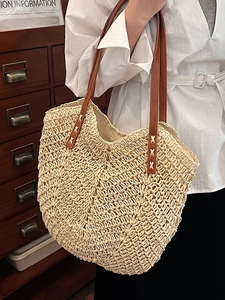 Chic natural straw tote bag with brown leather handles for casual summer beach vacations
