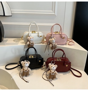 Minimalist faux leather Boston bags in white, pink, black, and burgundy with bear charms