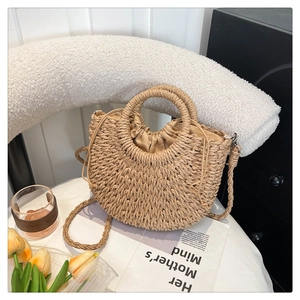 Detail of hand-woven straw bag with round handle and secure drawstring lining for vacation