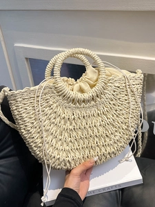 Minimalist cream handwoven straw basket bag with dual handles and crossbody strap