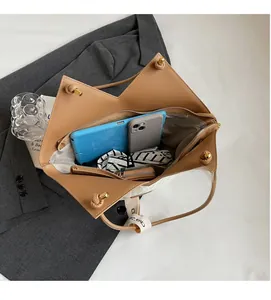 Top view of large capacity tote bag interior with storage compartments and daily items