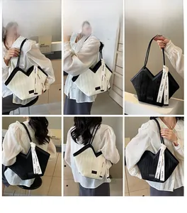 Detail of contrast color tote bag with vertical pleated texture and stylish ribbon