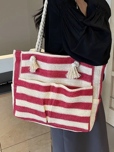 Red and white striped woven tote bag with rope handles and front pockets for summer beach