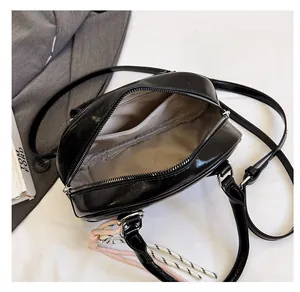 Interior view of black glossy bowling bag showing spacious compartments and grey lining