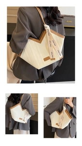 Detail view of large contrast tote bag with V-shaped opening and stylish silk scarf strap