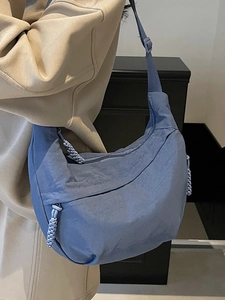 Blue nylon crescent dumpling crossbody bag for women with adjustable strap and woven zipper pull