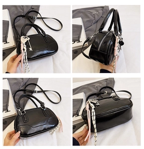 Detail view of black patent leather bowling bag with heart charm and tassels in four angles