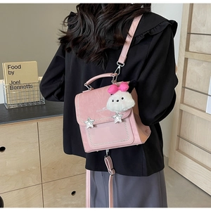 Pink PU leather crossbody bag featuring silver star studs and cute plush charm detail