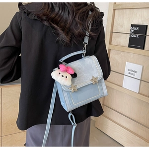 Detail of light blue vintage crossbody bag with pearl studs and a cute cloud charm