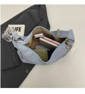 Internal view of a light blue soft leather tote showing large capacity and inner pocket