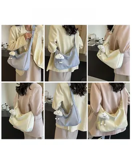 Detailed model views of large hobo shoulder bags in light blue and cream colors