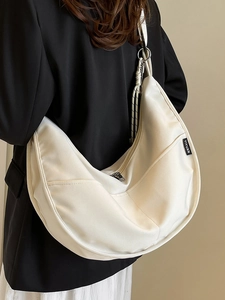 Minimalist beige canvas crescent bag with crossbody strap for women in high quality