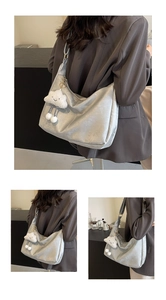 Detail view of silver metallic hobo bag with a white fluffy cloud charm pendant