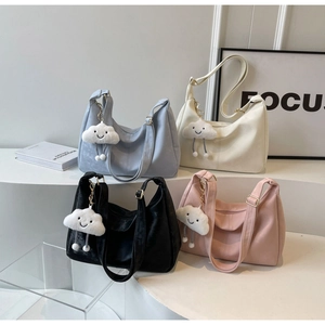 Soft leather tote bags in light blue, beige, black, and pink with plush cloud charms