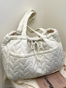 Minimalist cream quilted tote bag with drawstring closure and large front pocket