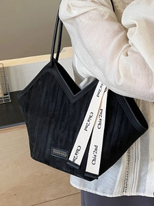 Chic black zebra texture tote bag with stylish v-shaped opening and decorative ribbon