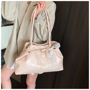 Detail of light pink tote bag with delicate white lace bow and pearl decoration