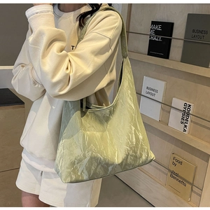 Detail shot of the mint green wrinkled faux leather tote bag with glossy finish and large capacity
