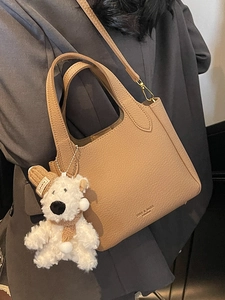Minimalist lychee pattern bucket bag in light brown with a cute plush bear charm