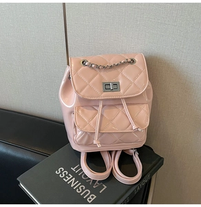 Pink patent leather mini backpack featuring diamond quilting and silver chain detail