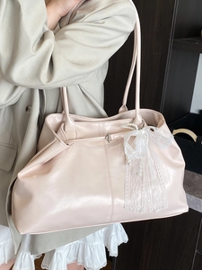 Glossy beige faux leather tote bag with lace bow and pearl charm for elegant women