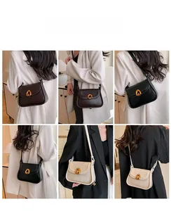 Detail view of women's saddle bags in coffee, black, and beige with horseshoe metal buckles