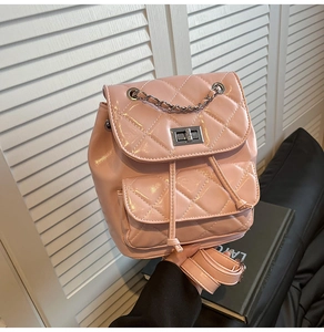 Detail of pink quilted shiny leather backpack with silver chain strap and metal turn-lock