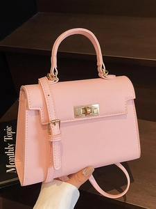 Pink minimalist trapezoid handbag with gold rotating lock and cross-pattern leather texture