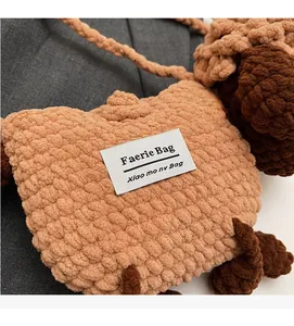 Detail of handmade crochet sheep bag with chunky knit texture and Faerie Bag label