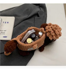 Macro shot of brown knit sheep bag interior showing storage space for phone and makeup
