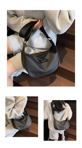 Detail of black nylon dumpling bag with adjustable wide strap and double metal zippers