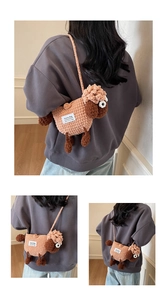 Detailed macro view of handmade crochet sheep crossbody bag with textured wool and woven strap