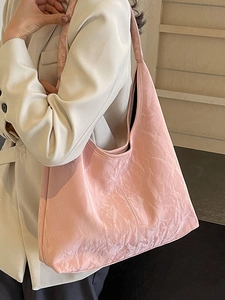 Pink oversized tote bag with wrinkled texture and wide shoulder strap for women