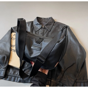 Detail of waterproof nylon crossbody bag with adjustable wide strap and metal double zippers