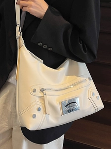 Sac bandoulière beige style motard avec rivets et texture en cuir lisse élégante