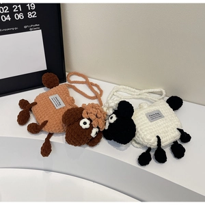 Detailed macro view of handmade wool crochet sheep bags with 3D knitted texture