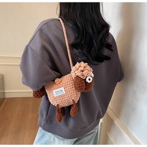 Detailed close-up of a handmade crochet sheep crossbody bag showing knitted wool texture