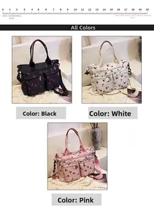 Detail view of cherry print canvas tote bags in black, white, and pink with front zip pockets