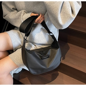 Modern black nylon crescent crossbody bag shown on model for casual everyday style