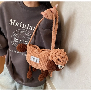 Close-up of a brown knit sheep crossbody bag with fluffy texture and side fabric label