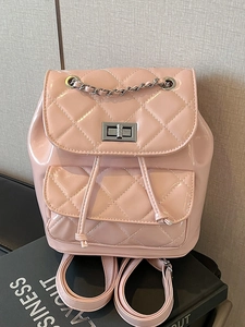 Pink quilted patent leather backpack with silver chain handle and turn-lock closure