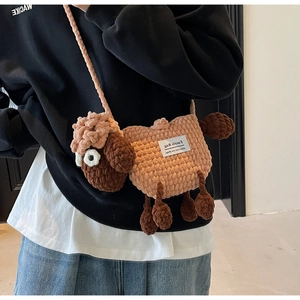 Detail of crochet sheep bag showing the Faerie Bag label and handmade knit texture