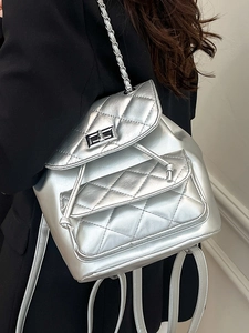 Silver quilted chain backpack for women featuring metallic finish and modern turn-lock closure