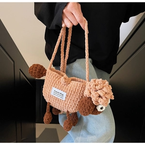 Detailed knit texture of handmade sheep crochet bag with crossbody strap and logo tag