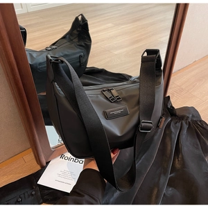 Detail of waterproof nylon dumpling bag with adjustable strap and dual zipper closure