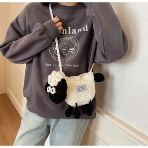 Detail showing handcrafted sheep crochet bag with Faerie Bag woven label and knit texture