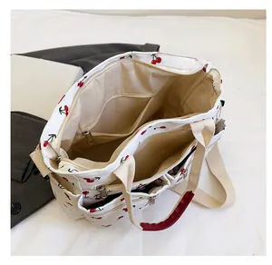 Internal view of cherry print tote bag showing multiple compartments and spacious storage